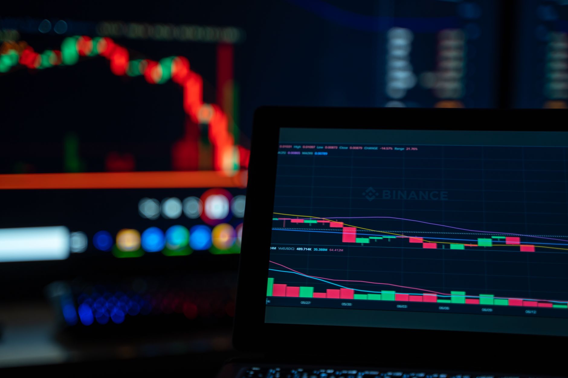 Bright trading screens depict cryptocurrency market trends in a tech setup.