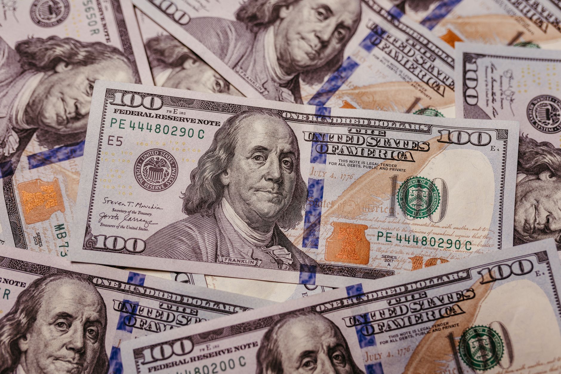 Stack of 100 dollar US banknotes with Benjamin Franklin portrait.